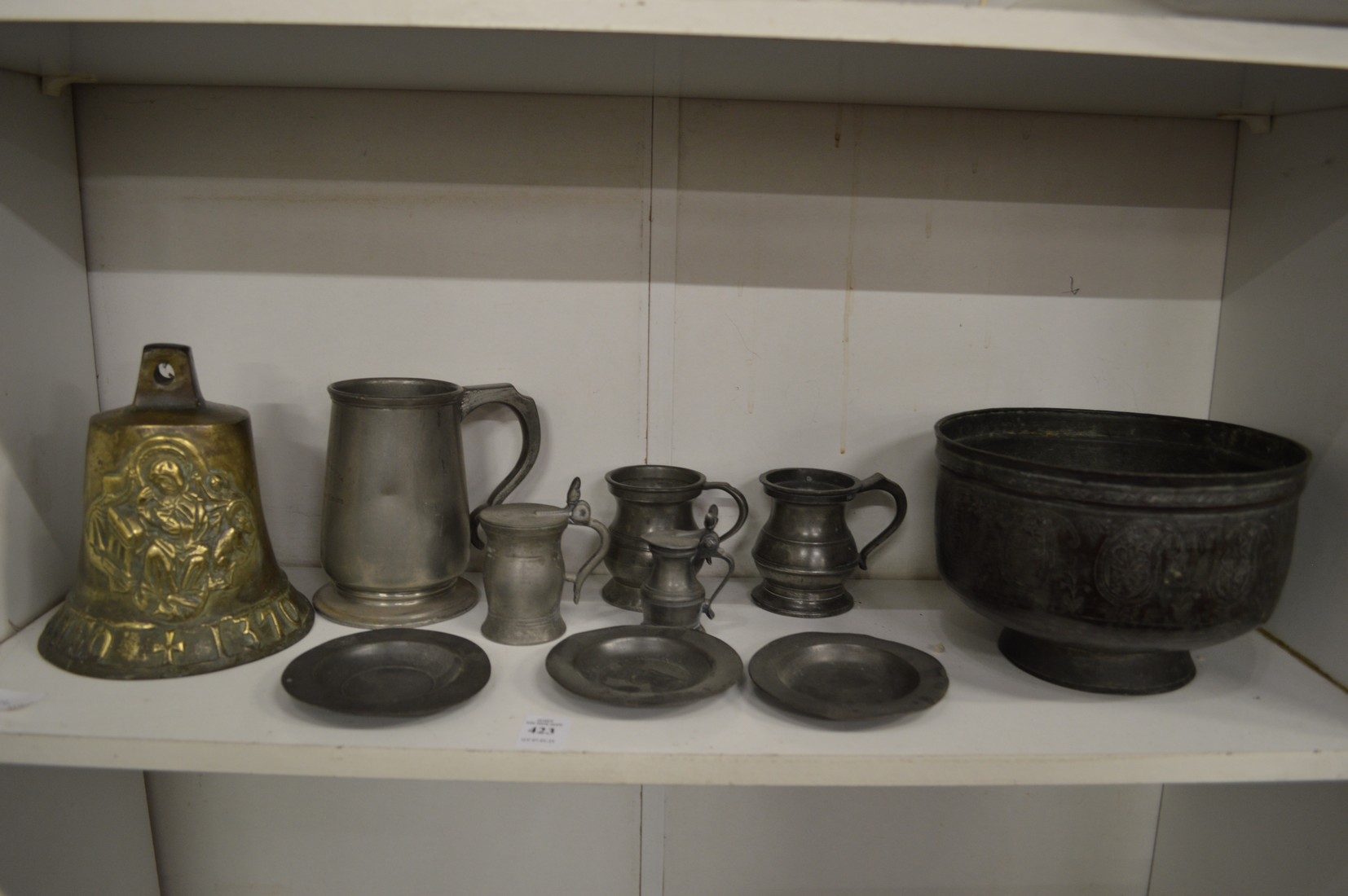 An Islamic tinned copper bowl, items of pewter and a bronze bell.