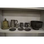 An Islamic tinned copper bowl, items of pewter and a bronze bell.