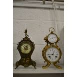 Two decorative mantel clocks.