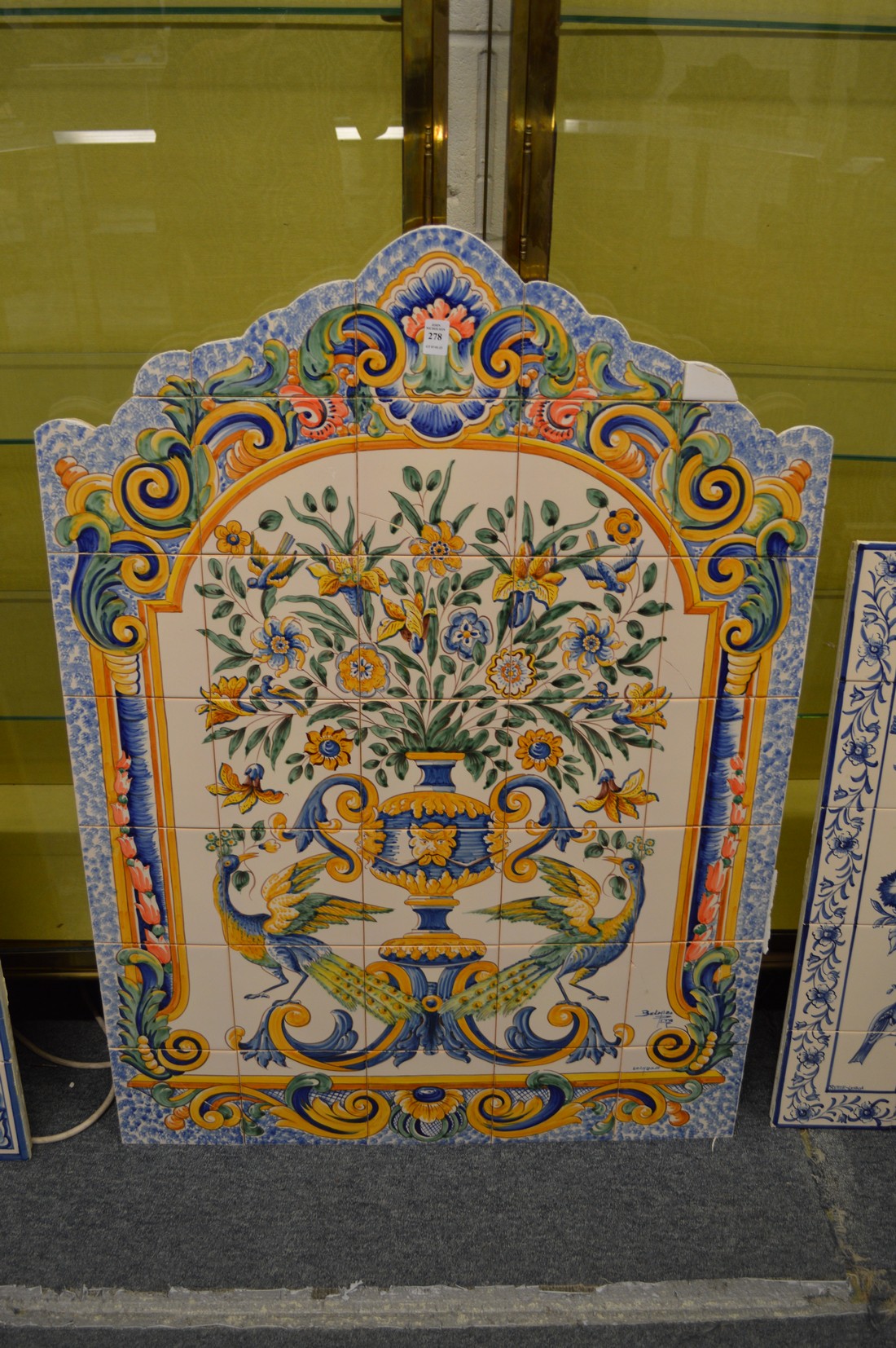 A colourful Continental style tile picture depicting flowers in a vase.