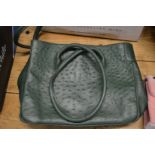 A ladies green leather handbag.