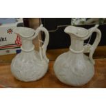 Two white moulded pottery jugs.