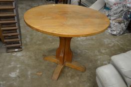 An oak circular pedestal table.