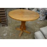 An oak circular pedestal table.