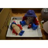 A wooden tray containing Paddington bears.