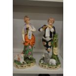 A pair of pottery figure groups.