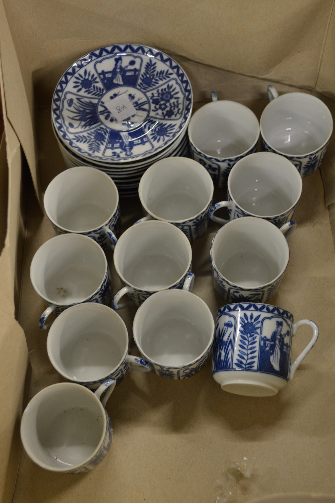 A group of Japanese blue and white cups and saucers.