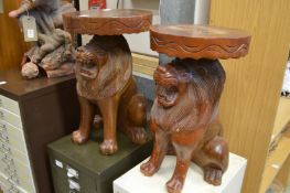 Two carved wood plant stands modelled as seated lions.