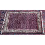 A PERSIAN RUG, dark blue ground central panel with stylised Boteh decoration. 4'10" x 3'1"