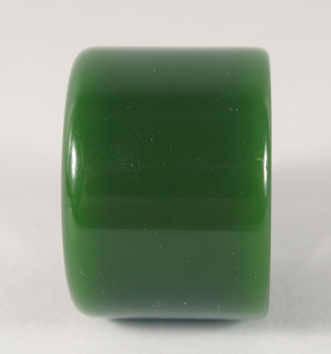 A DARK GREEN JADE ARCHERS RING. 3.5cm diameter. - Image 2 of 2