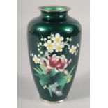 A JAPANESE GREEN GROUND CLOISONNE VASE, decorated with flowers, 18cm high.
