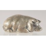 A RUSSIAN CAST SILVER MODEL OF A RECUMBENT PIG. 6cm long.