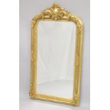 A DECORATIVE VICTORIAN STYLE GILT FRAMED OVER MANTLE MIRROR. 5ft 3ins high x 2 ft 9ins wide.