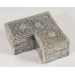 A CHINESE SILVER "L" SHAPED BOX AND COVER, with embossed and engraved decoration. 7cm wide.