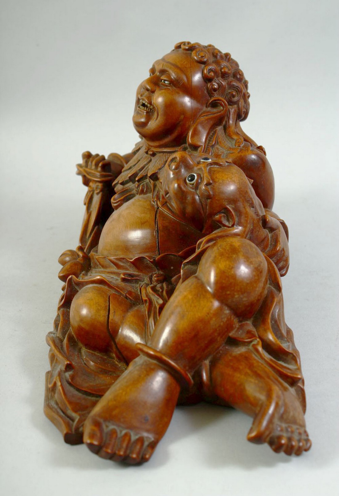 A LARGE CARVED HARDWOOD HOTEI, on a fitted carved hardwood stand, the figure reclining with a - Image 6 of 7