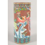 A CHINESE YIXING CYLINDRICAL BRUSH POT, painted with exotic birds, 28.5cm high.
