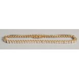 A GOOD 18CT YELLOW GOLD AND DIAMOND LINE BRACELET. 5 carats.