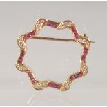 AN 18CT GOLD, DIAMOND AND RUBY BROOCH. 2.5cm diameter