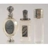 THREE SILVER MOUNTED CUT GLASS SCENT BOTTLES.