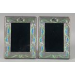 A PAIR OF SILVER AND ENAMEL PHOTOGRAPH FRAMES. 19.5cm high