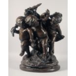 A LARGE AND IMPRESSIVE BRONZE GROUP OF THREE PLAYFUL CHERUBS. 22ins high.