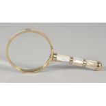 A SMALL MAGNIFYING GLASS with MOTHER OF PEARL handle.