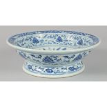 A CHINESE BLUE AND WHITE PORCELAIN FOOTED BOWL, painted with a central floral spray and lotus, the