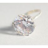 A SILVER LARGE CUBIC ZIRCONIA SOLITAIRE RING.