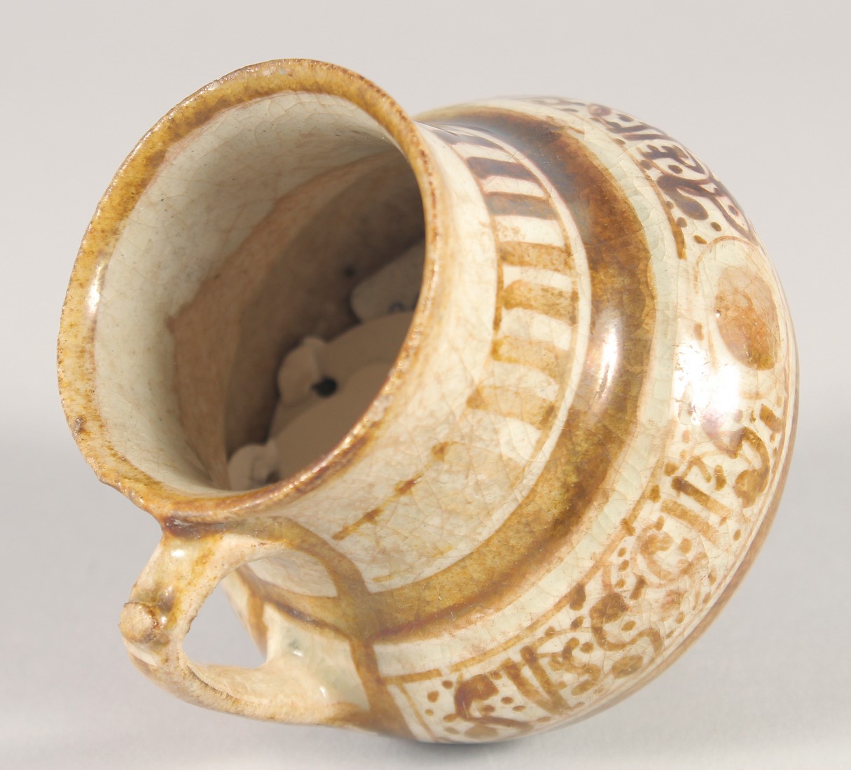 A SMALL KASHAN LUSTRE GLAZE POTTERY EWER, with provenance sticker; Christie's, 9cm high. - Image 5 of 7