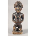 AN ANTIQUITY, PRE-COLOMBIAN SOUTH AMERICAN POTTERY SEATED FIGURE. 6ins high.