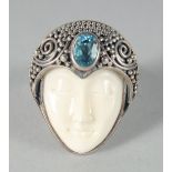 A SILVER AND ENAMEL ART DECO FACE RING.