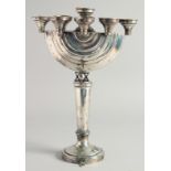 A GOOD JEWISH SILVER MENORAH on a circular base. 12ins high.