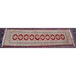 A PERSIAN DESIGN RUNNER, cream and red ground with a single row of ten gulls. 9'0" x 2'7"