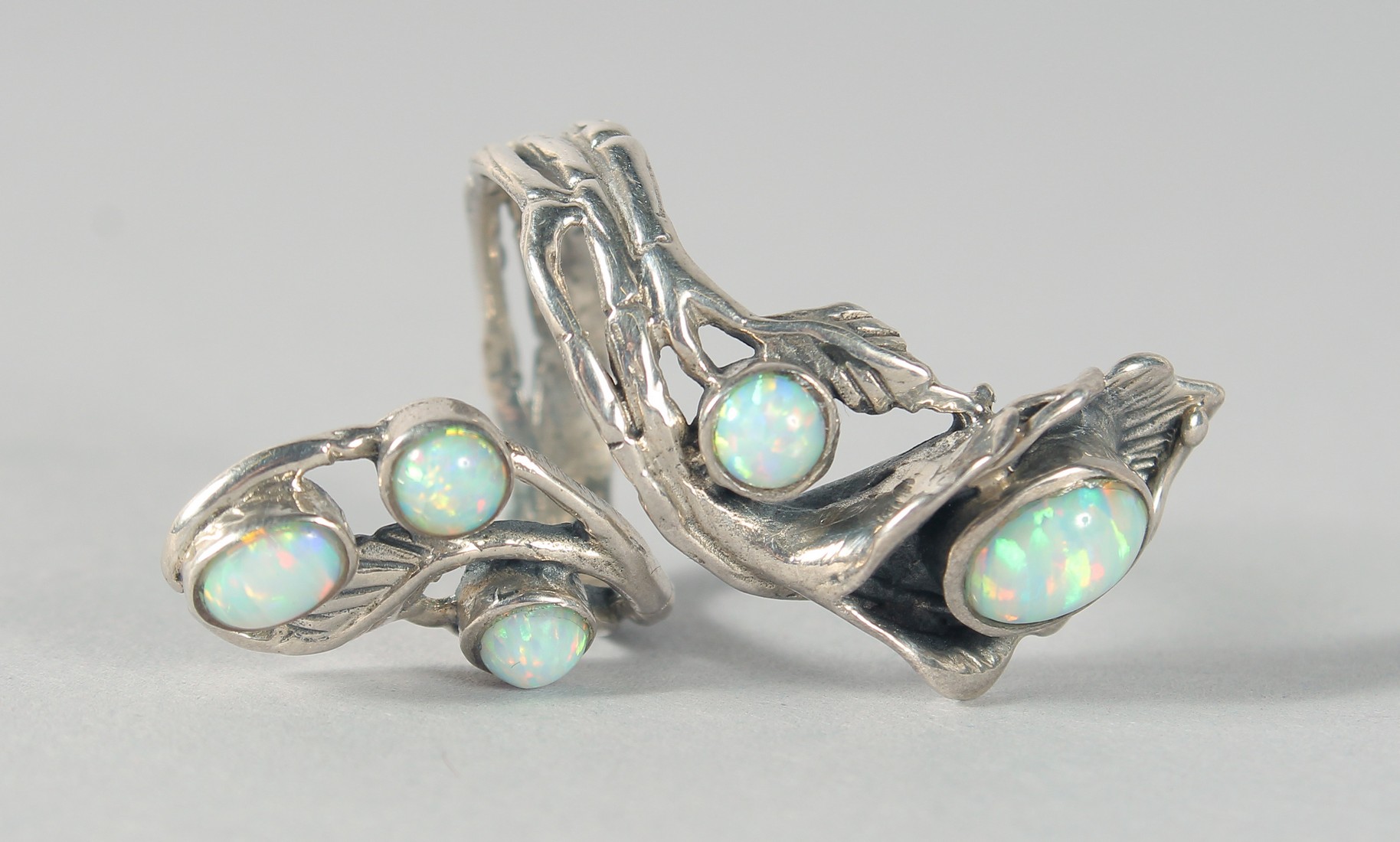 A SILVER REAL OPAL NATURALISTIC SET RING.