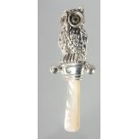 A SILVER OWL RATTLE.