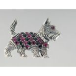 A SILVER SCOTTIE DOG BROOCH.