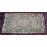 A PERSIAN DESIGN RUG, pastel shades with geometric decoration. 5'7" x 3'3"