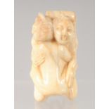 A CHINESE CARVED BONE EROTIC NETSUKE. 4.5cm