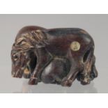 A CARVED WOOD NETSUKE modelled as horses. 4.5cm long.