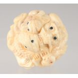 A JAPANESE BONE NETSUKE carved with animals. 3.5cm diameter.