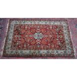 A GOOD PERSIAN CARPET, burgundy ground with parrots amongst flora and forna. 7'0" x 4'8"