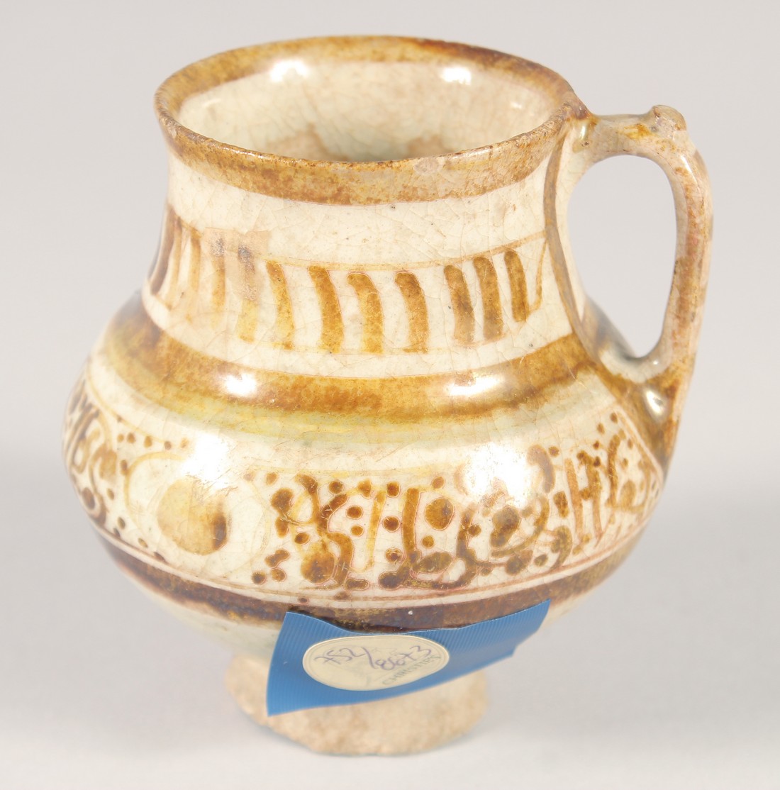 A SMALL KASHAN LUSTRE GLAZE POTTERY EWER, with provenance sticker; Christie's, 9cm high. - Image 3 of 7