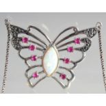 A SILVER RUBY AND OPAL BUTTERFLY PENDANT AND CHAIN.