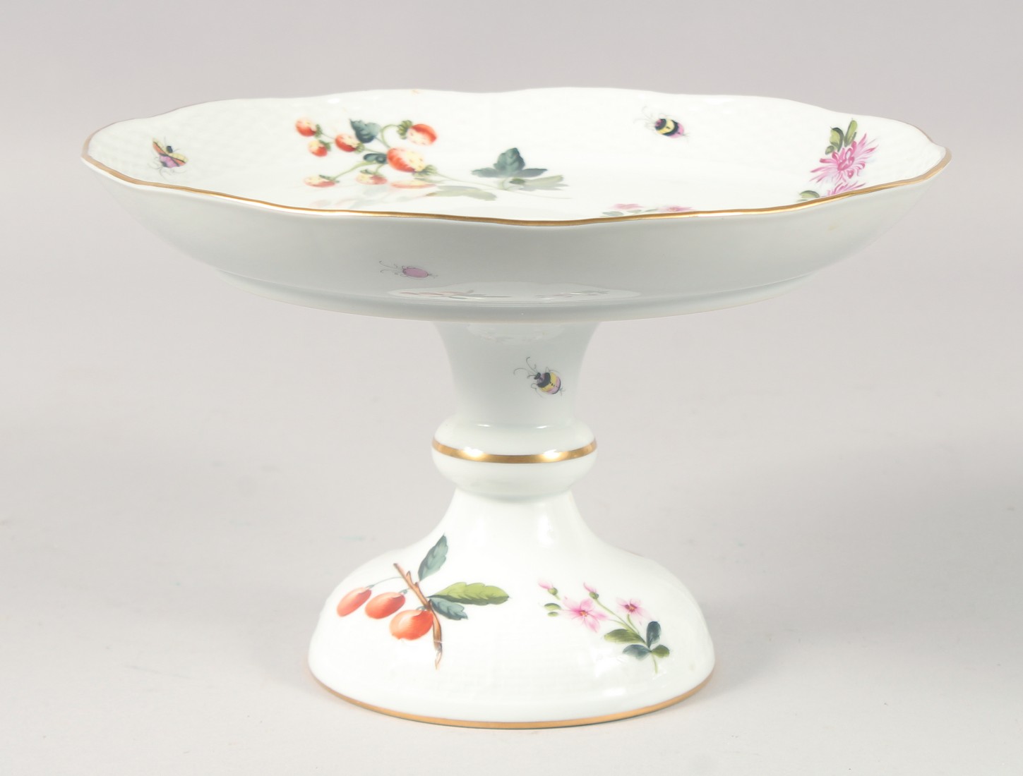 A HEREND CIRCULAR PEDESTAL CAKE STAND painted with flowers, No. 311 FAC. 8.5ins diameter.