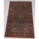 A GOOD PERSIAN CARPET, dark blue ground with floral decoration, attached label; Barin Carpets