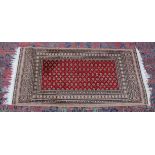 A MODERN PERSIAN DESIGN RUG, central red ground with all over stylised decoration. 4'7" x 2'3".