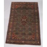 A GOOD PERSIAN CARPET, dark blue ground with floral decoration, attached label; Barin Carpets