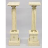 A PAIR OF BEIGE MARBLE PEDESTAL COLUMNS. 3ft 3ins high.