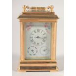 A BRASS MINIATURE CARRIAGE CLOCK with Sevres style porcelain panels. 3ins high.