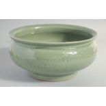 A LARGE CHINESE CELADON GLAZE BOWL, carved with dragon and the flaming pearl of wisdom, 25.5cm